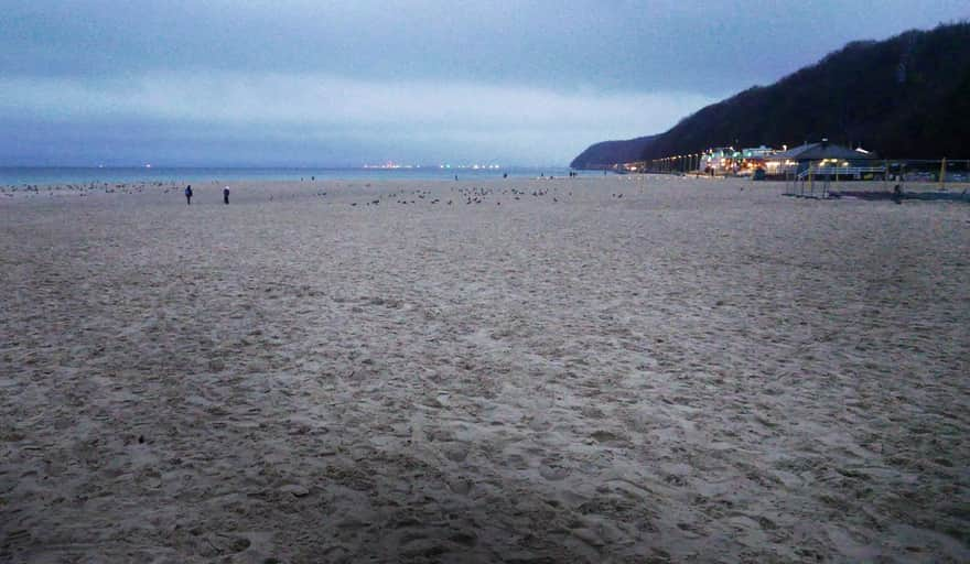 Winter by the sea. City beach in Gdynia - view of Kępa Redłowska