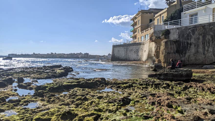 Small rocky beach with a view of Ortigia at the end of Via Cimone street