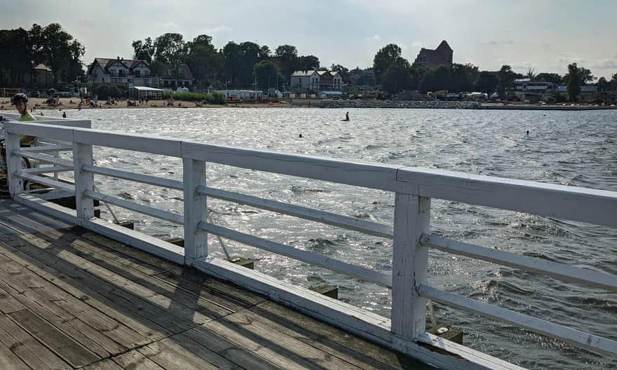 Puck Pier. In the background, the silhouette of the Gothic Church of Sts. Peter and Paul