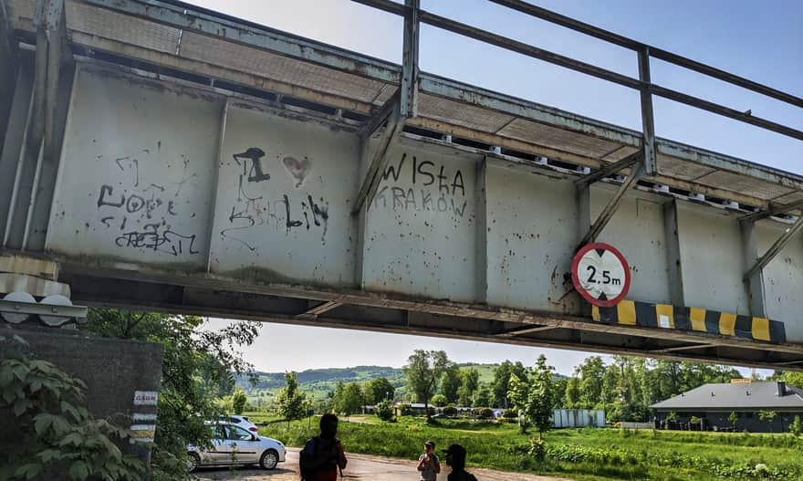 Yellow trail in Mszana Dolna, Zielona Street. Parking bays under the railway viaduct over Mszanka River.