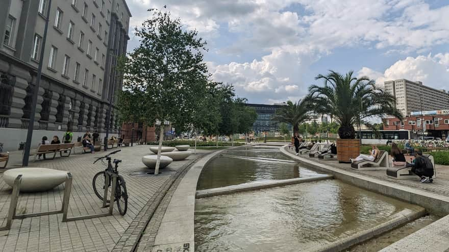 Wooden sun loungers near the fountain in Katowice Market Square