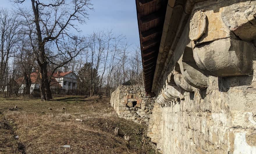 Lower Castle in Rożnów - beluard. Tarnowski family coat of arms - Leliwa. In the background, the 19th-century Stadnicki manor (private property).